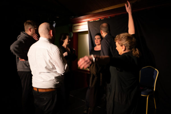 Rhiannon coaching a group of improvisers